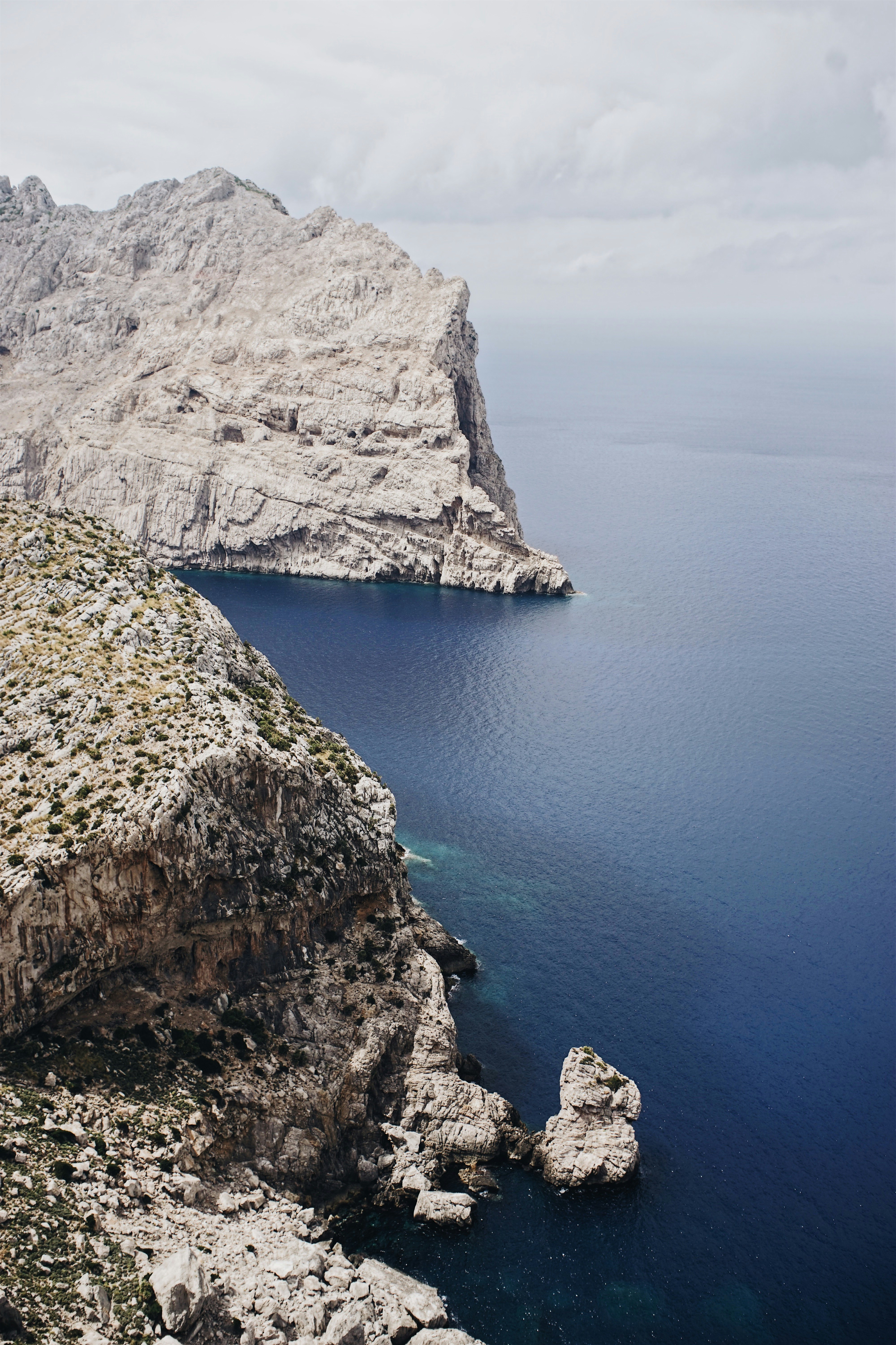 photo of grey rocks surrounded on sea water